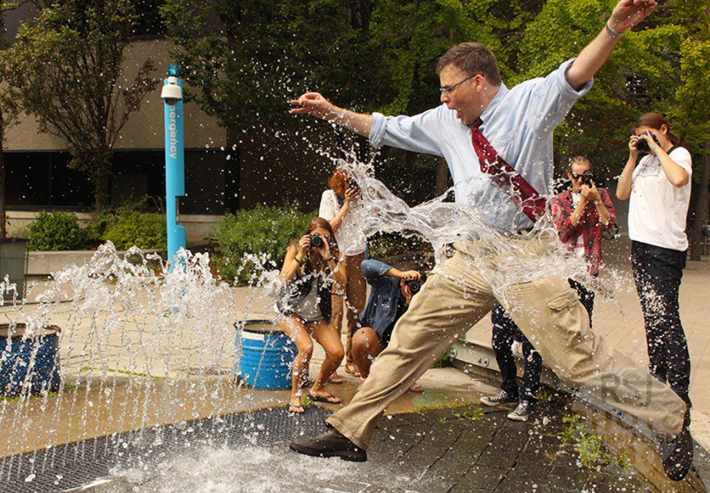 Instructor Gary Gould jumping through a water fountain